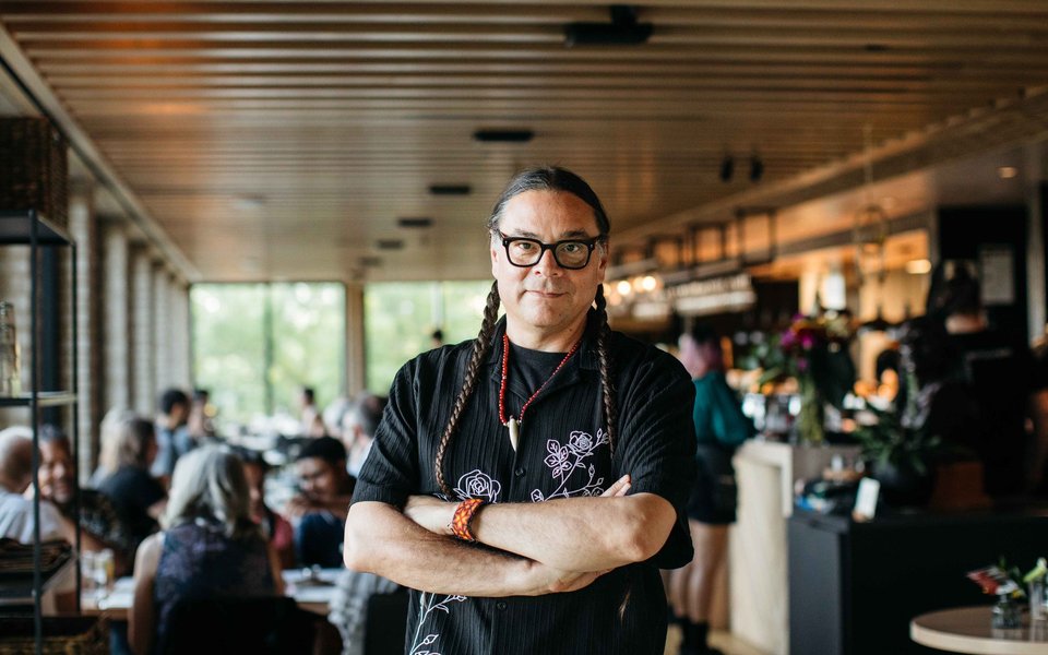 Chef Sean Sherman poses in the original Owamni restaurant space (Caitlin Abrams)
