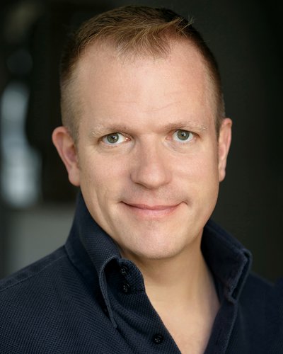 A headshot of Alexander Dodge