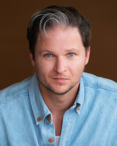 A headshot of Dustin Bronson