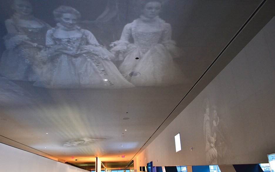 Printed on 7,000 sheets of onionskin paper, the production images on our walls and ceilings create a theatrical narrative throughout the building